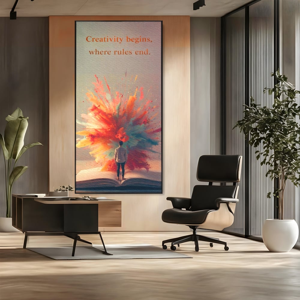 Tablou canvas cu tablou canvas cu barbat privind o explozie de culoare dintr-o carte deschisa, in rama de aluminiu negru, pe perete intr-un birou